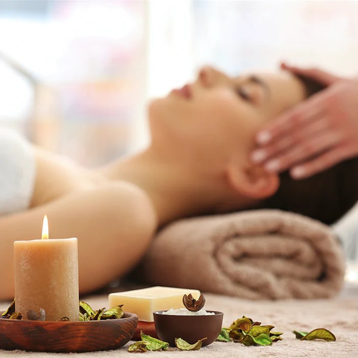 Vacker kvinna blir masserad under aromaterapi.